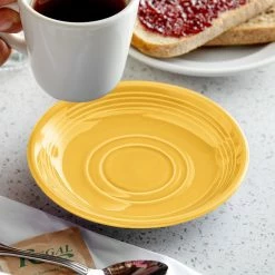 Tuxton CSE-060 Concentrix 6" Saffron China Saucer - 24/Case