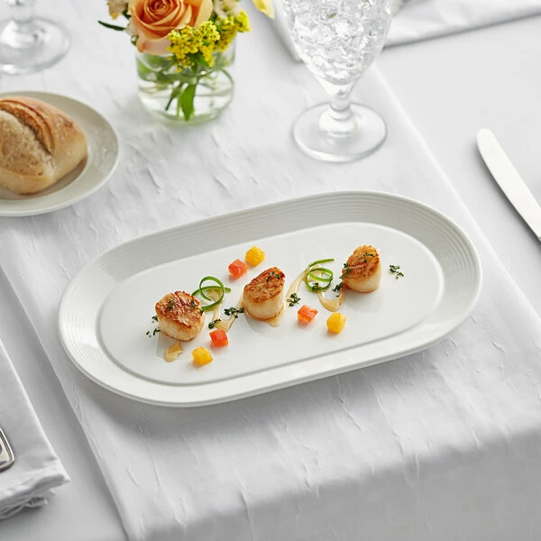 Acopa Liana 12" X 7 1/4" Bright White Embossed Lines Wide Rim Porcelain Platter - 12/Case 1 Acopa Liana 12" X 7 1/4" Bright White Embossed Lines Wide Rim Porcelain Platter - 12/Case