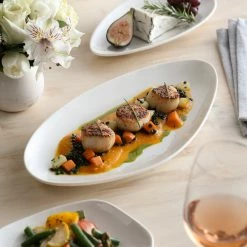 Acopa Nova 13" X 6 1/4" Cream White Slim Triangle Coupe Stoneware Plate - 12/Case