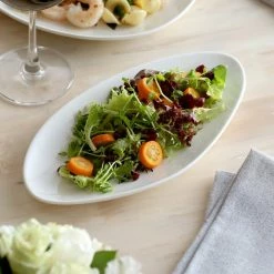 Acopa Nova 11" X 5 1/2" Cream White Slim Triangle Coupe Stoneware Plate - 12/Case