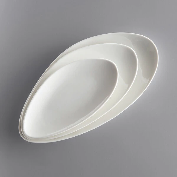 Acopa Nova 11" X 5 1/2" Cream White Slim Triangle Coupe Stoneware Plate - 12/Case 4 Acopa Nova 11" X 5 1/2" Cream White Slim Triangle Coupe Stoneware Plate - 12/Case - Image 4