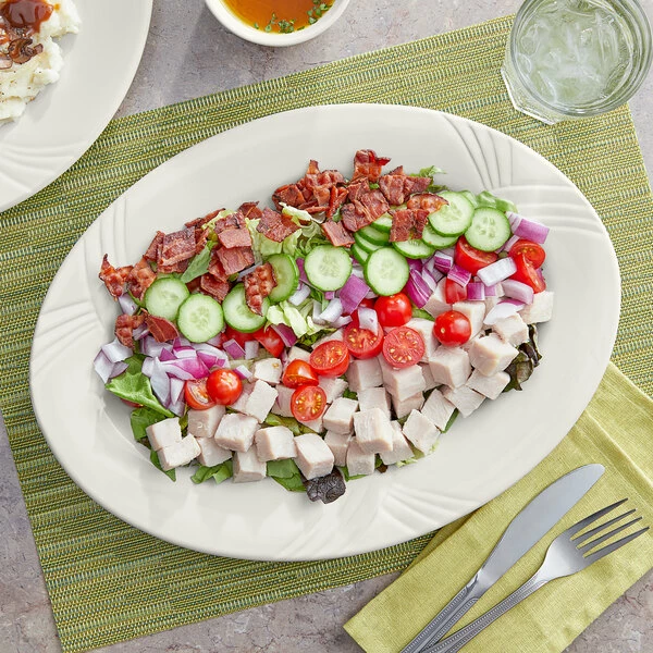 Acopa Swell 13 7/8" X 10 1/2" Ivory (American White) Embossed Wide Rim Oval Stoneware Platter - 12/Case 1 Acopa Swell 13 7/8" X 10 1/2" Ivory (American White) Embossed Wide Rim Oval Stoneware Platter - 12/Case