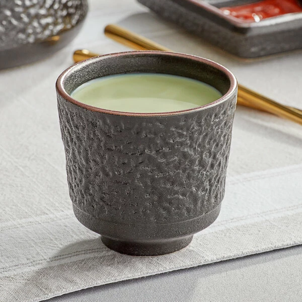 Acopa Heika 5 Oz. Black Matte Textured Stoneware Tea Cup - 12/Case 1 Acopa Heika 5 Oz. Black Matte Textured Stoneware Tea Cup - 12/Case