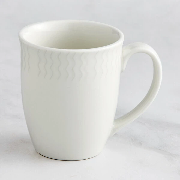 RAK Porcelain Leon 12.2 Oz. Ivory Embossed Porcelain Mug - 12/Case 1 RAK Porcelain Leon 12.2 Oz. Ivory Embossed Porcelain Mug - 12/Case