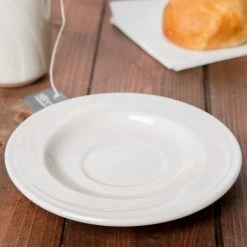 Syracuse China 950038431 Cascade 5 3/4" Ivory (American White) Round Medium Rim Flint Porcelain Tea Saucer - 36/Case